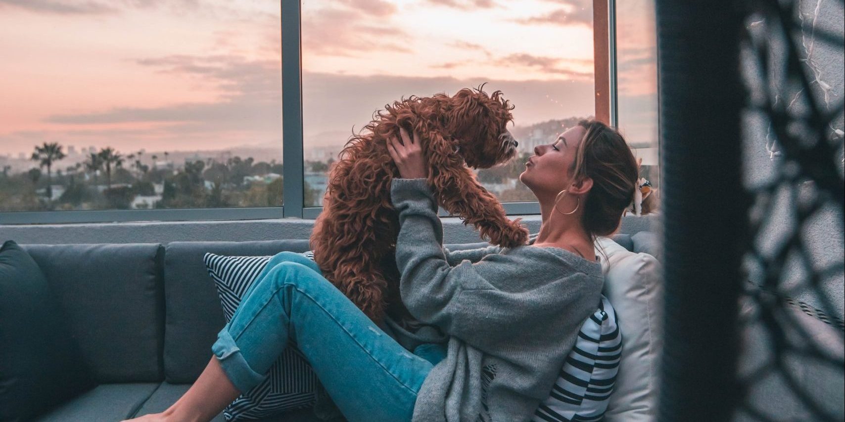 woman sitting on balcony with dog woman sitting on balcony with dog