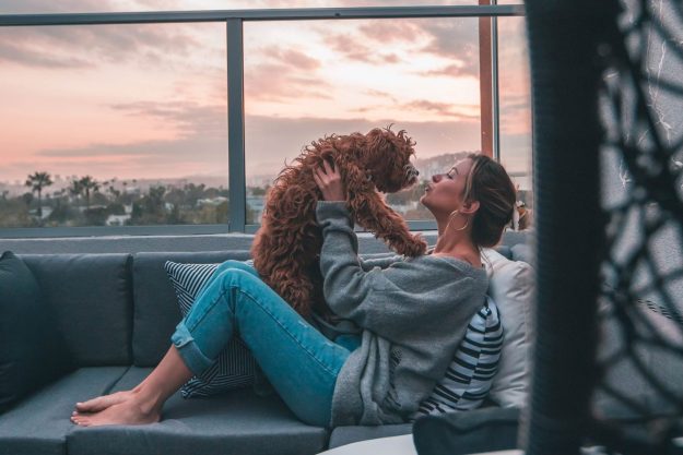 woman sitting on balcony with dog woman sitting on balcony with dog