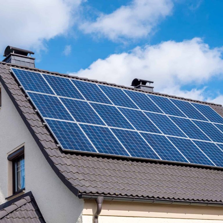 White-home-scallop-roof-and-solar-panels-shutterstock_1336991930-scaled-1-scaled